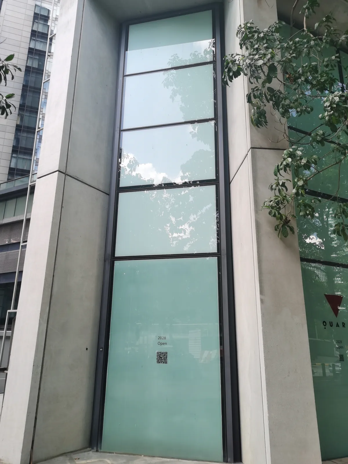 Storefront glass panels with hoarding film and stickers